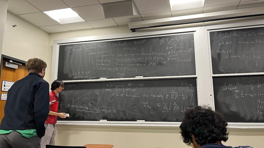 Terence Tao teaching analytic prime number theory at a blackboard, January 2025